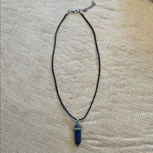 Silvertone wrapped gemstone point pendant on black leather necklace